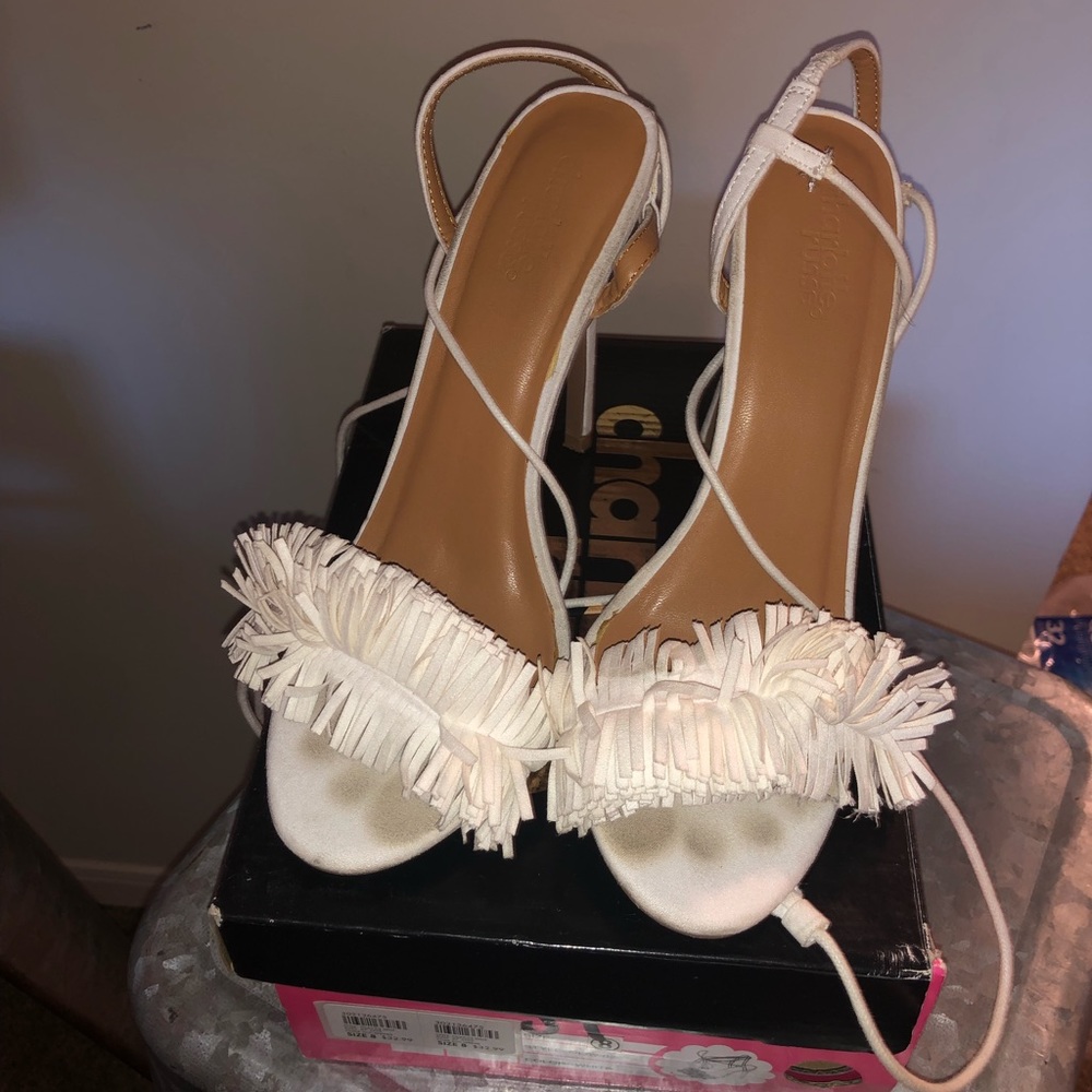 White sandal heel with strings that ties up leg.